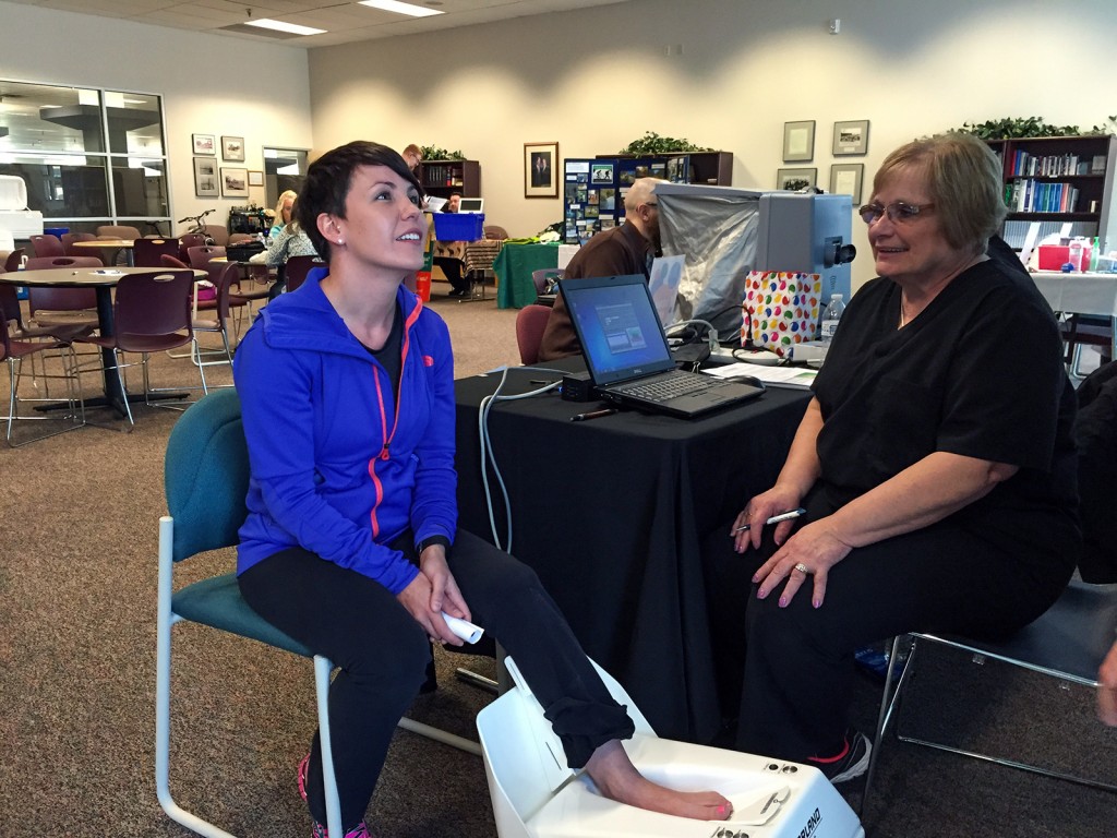 Woman getting bone density test at a health fair.