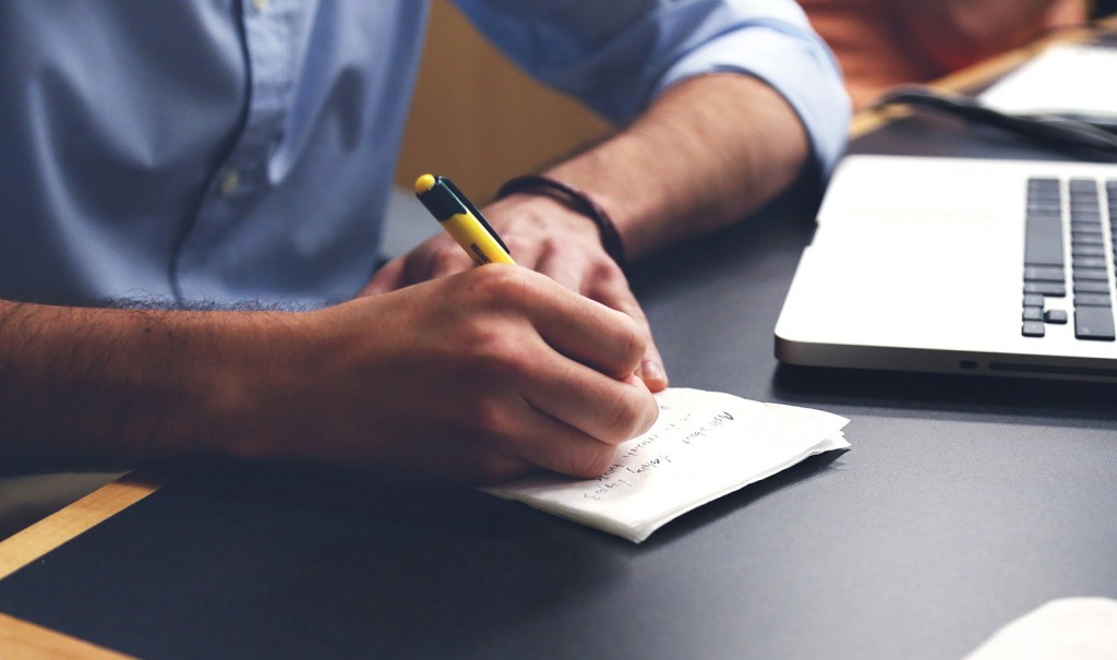 Man making a schedule in order to reduce stress at work.