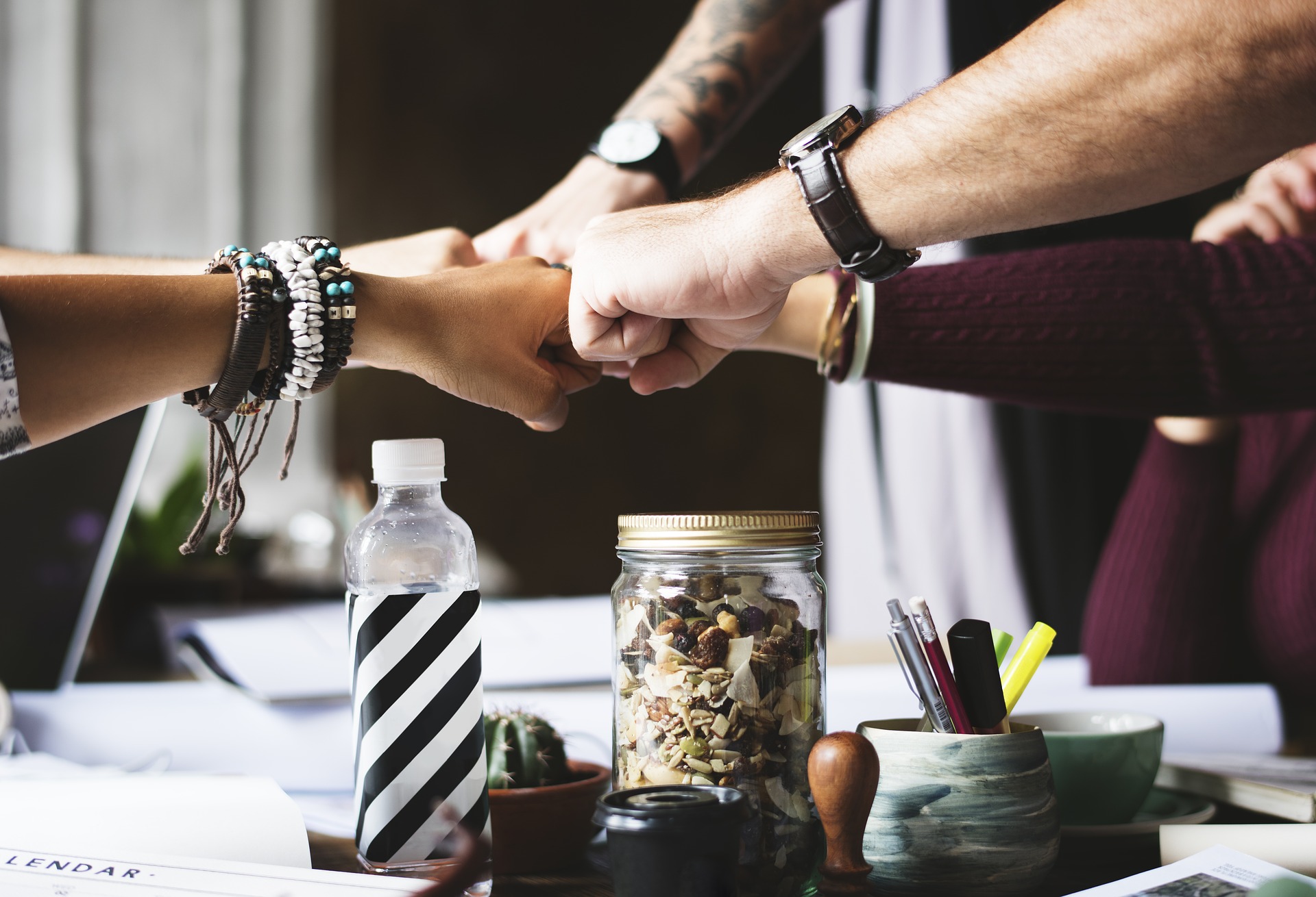 Coworkers putting fists together in collaboration