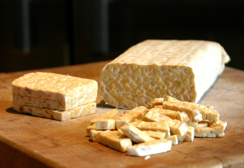 Sliced tempeh on cutting board