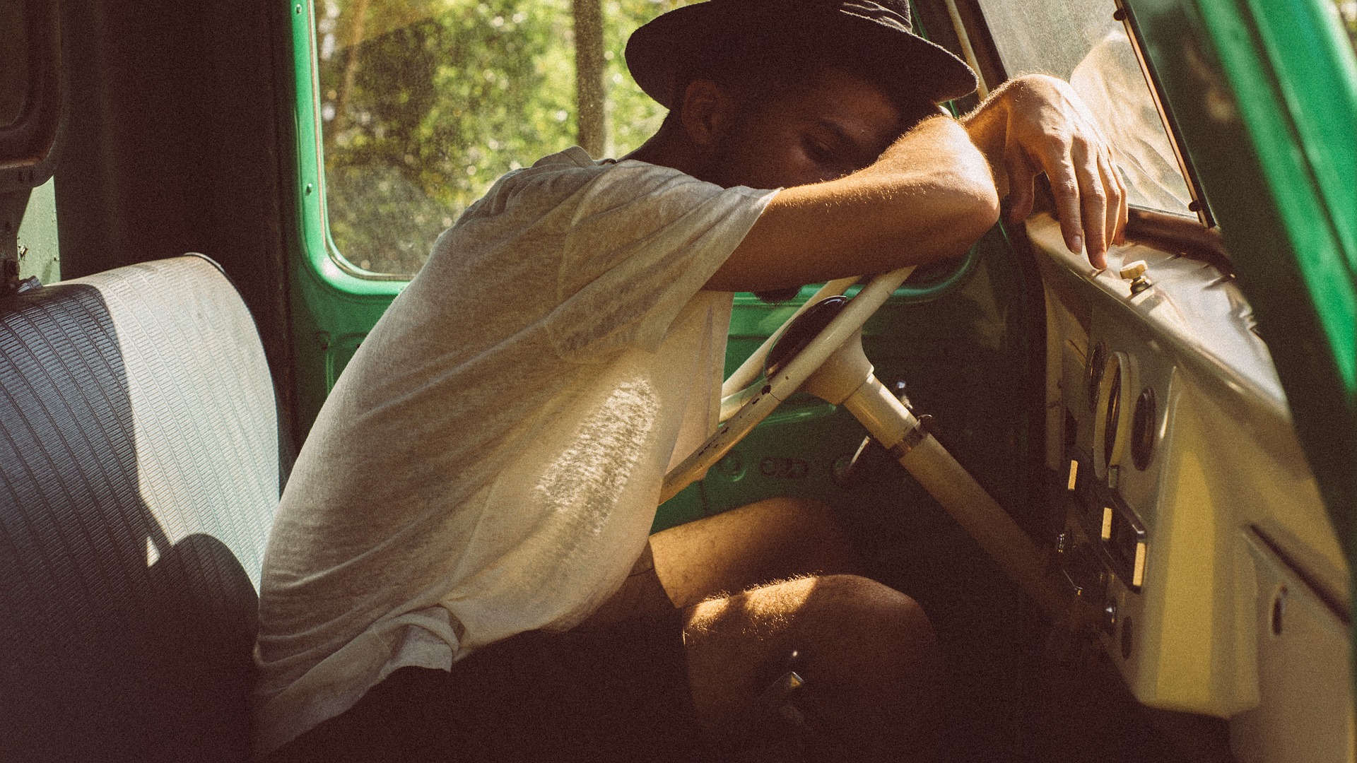 Man suffering from sleep deprivation sleeping at wheel of truck