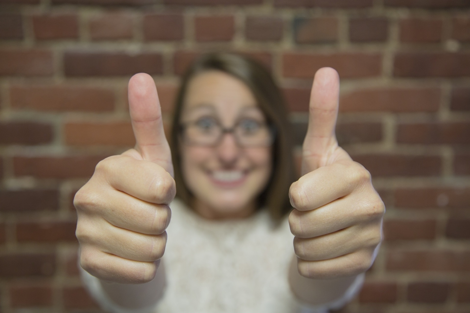 Happy woman giving two thumbs up