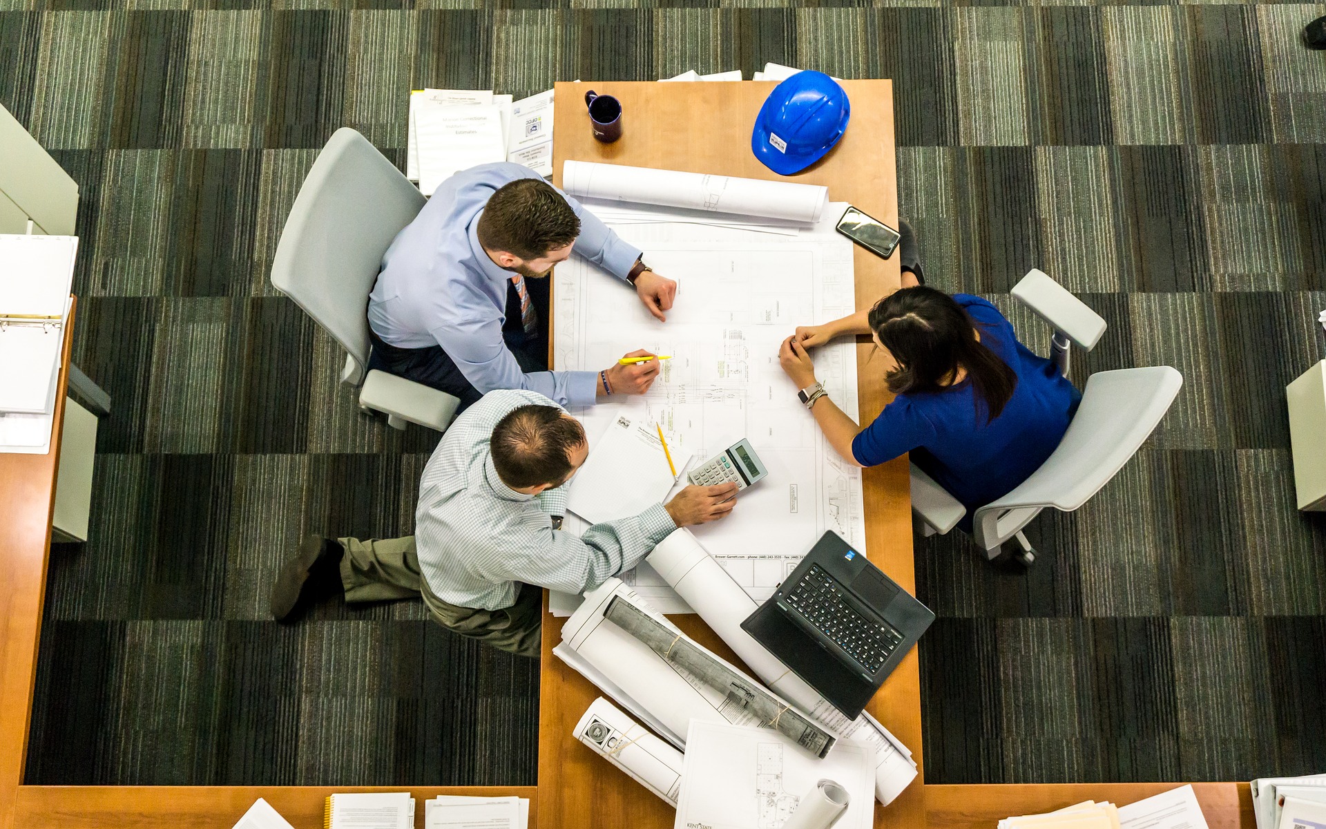 Overhead view of office team collaborating on an internal emergency response plan