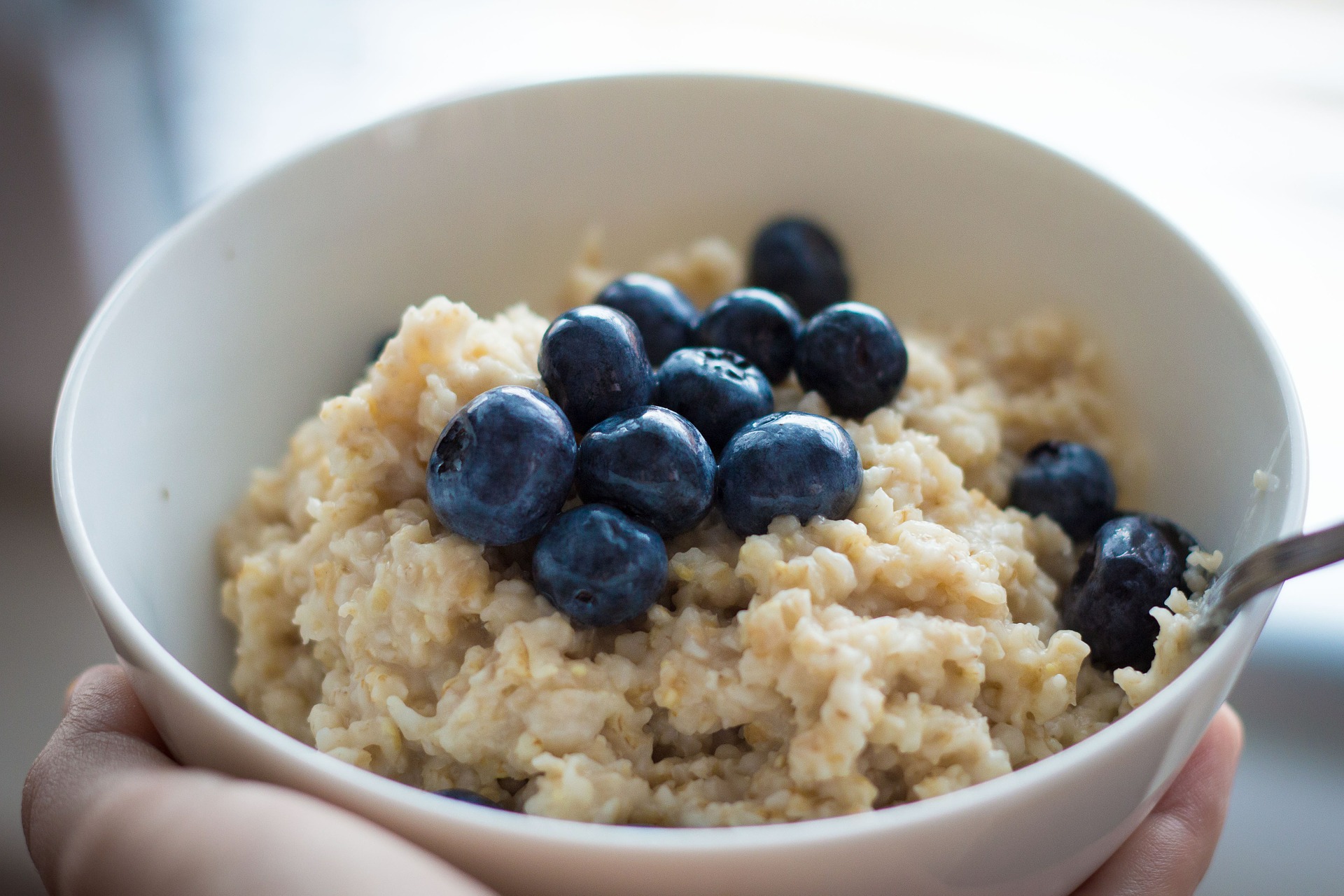 Oatmeal in a white bowl with blueberries on top
