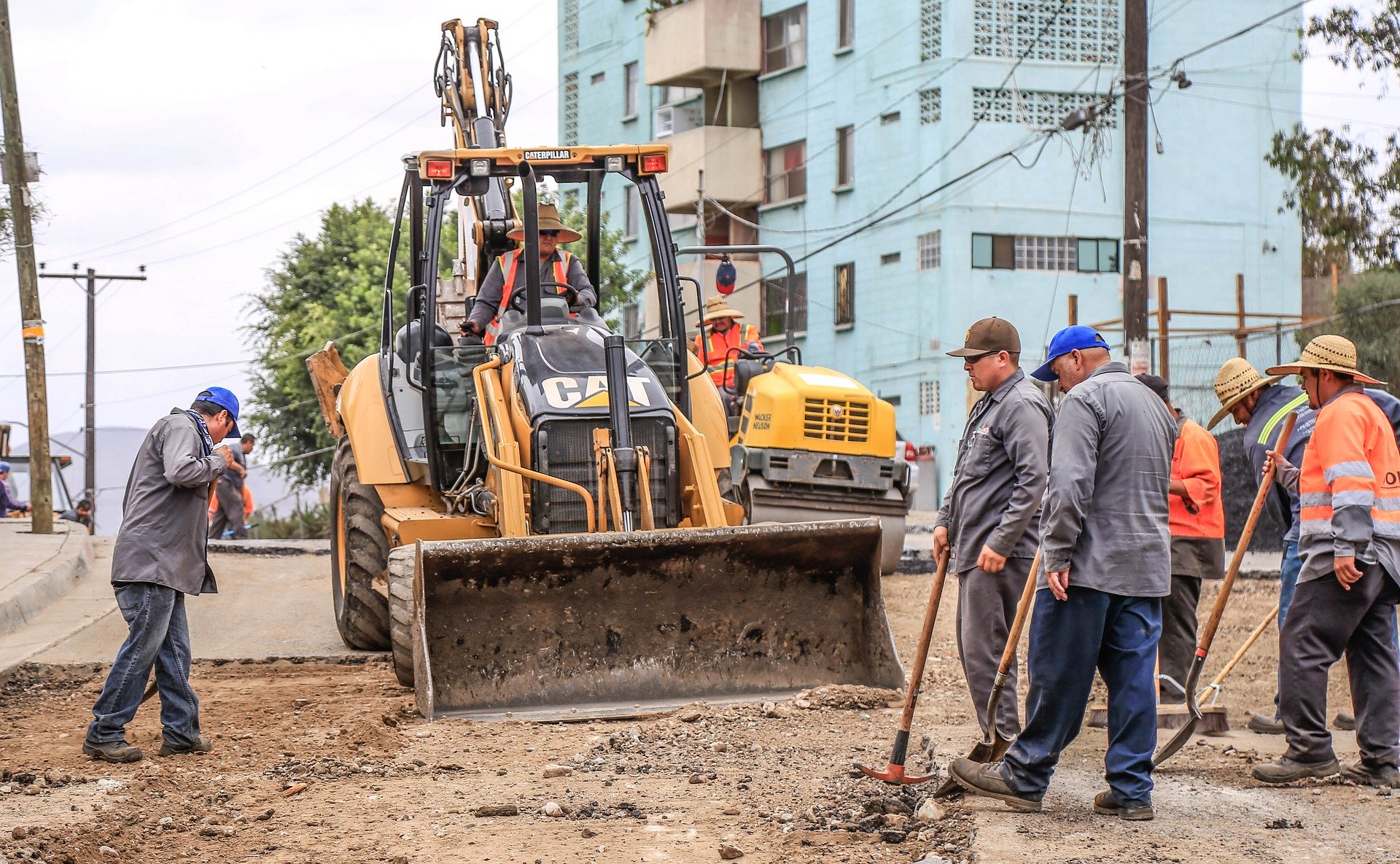 Men working in dirt near construction equipment