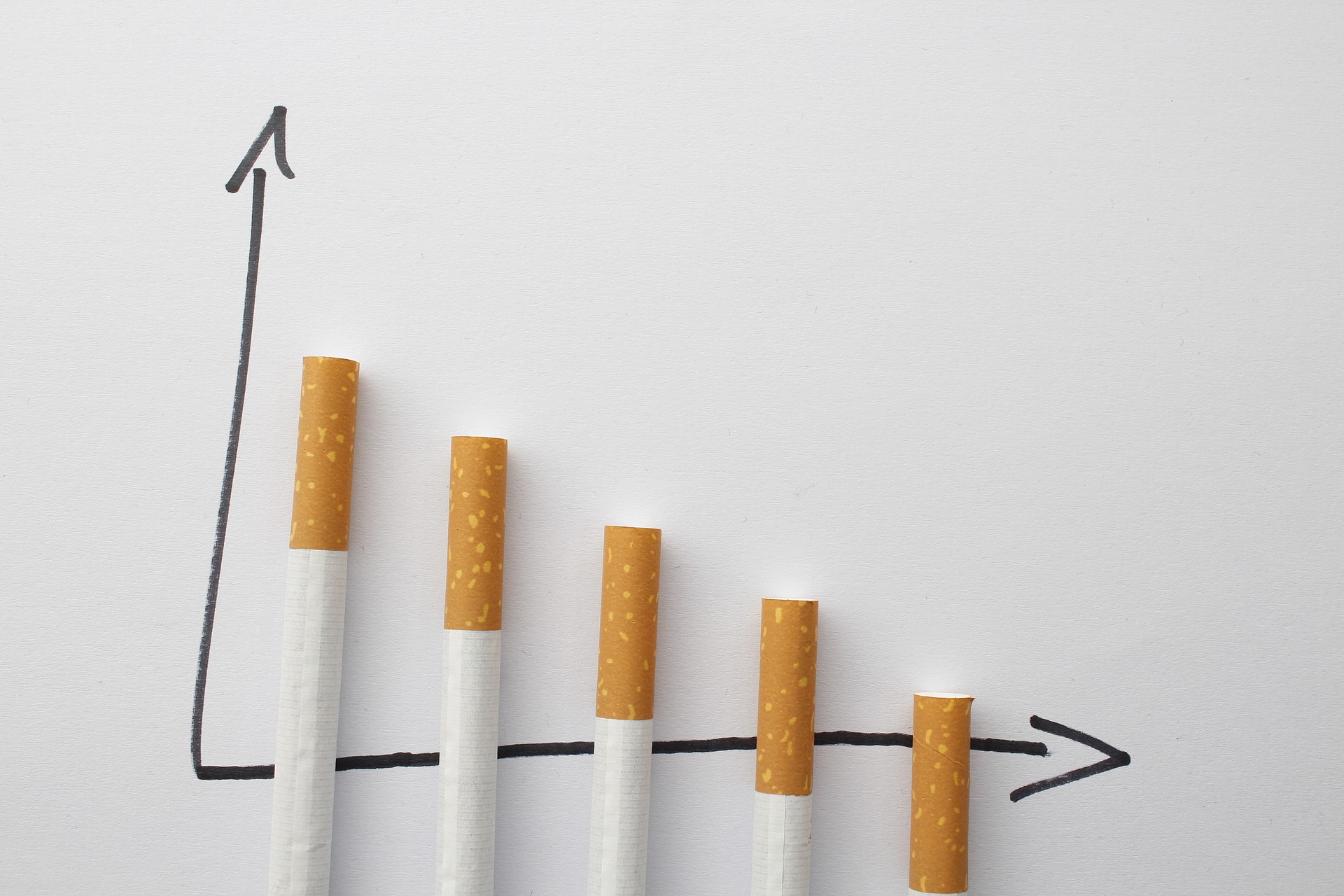 Cigarettes arranged on line graph to indicate process of quitting smoking  