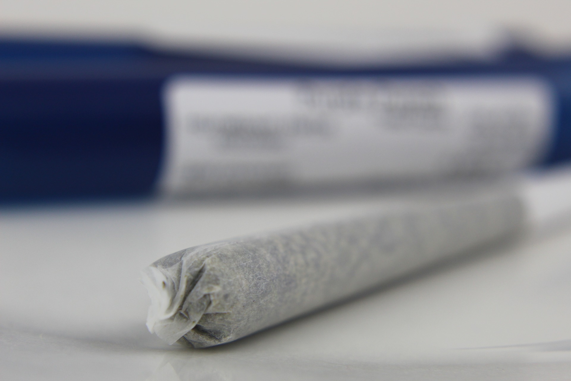 Cannabis joint on white table