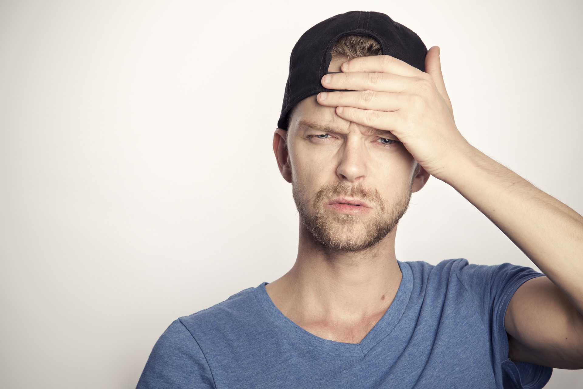 Man putting his hand to his forehead in frustration